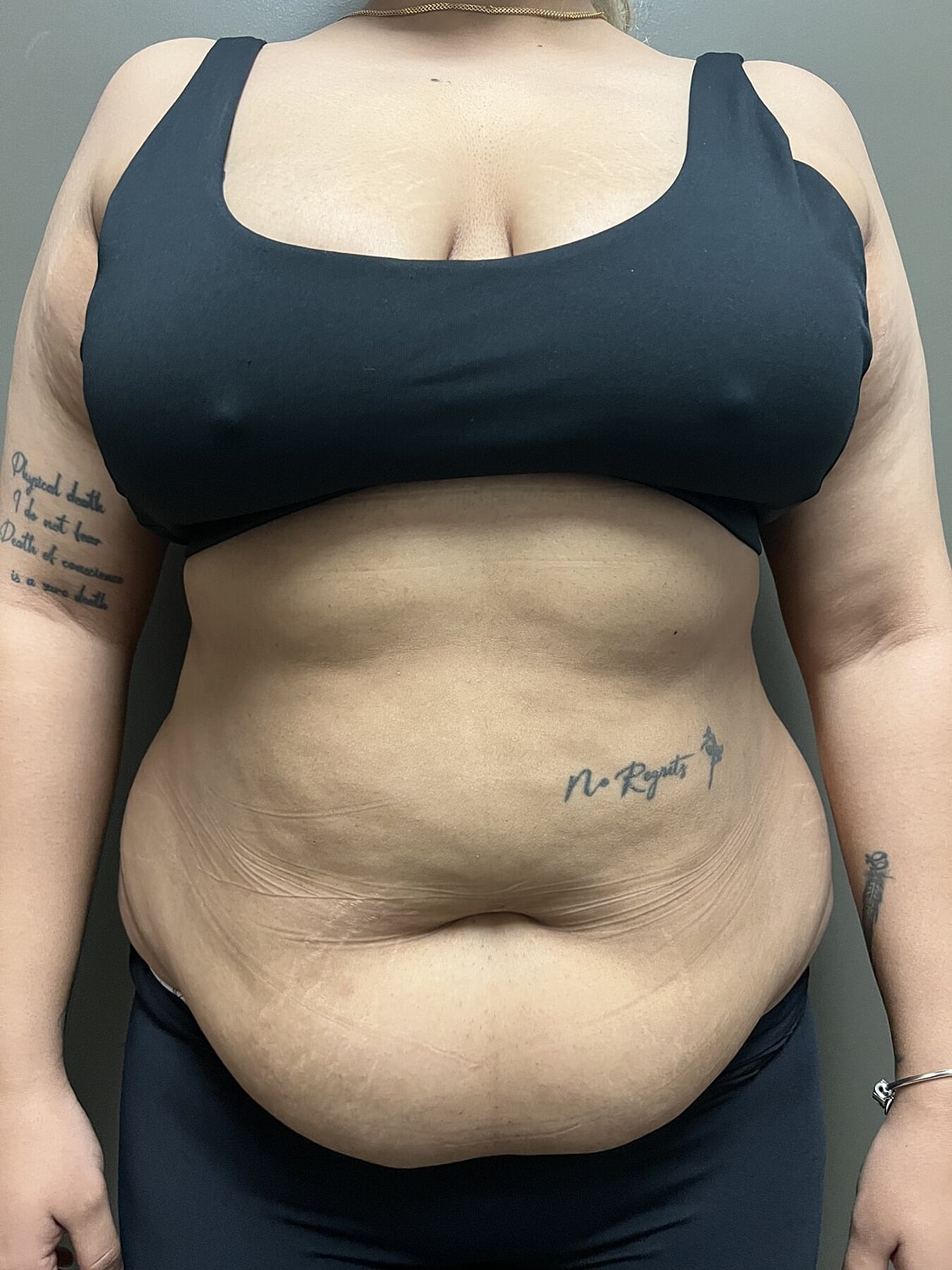 Person in black tank top showing body confidence